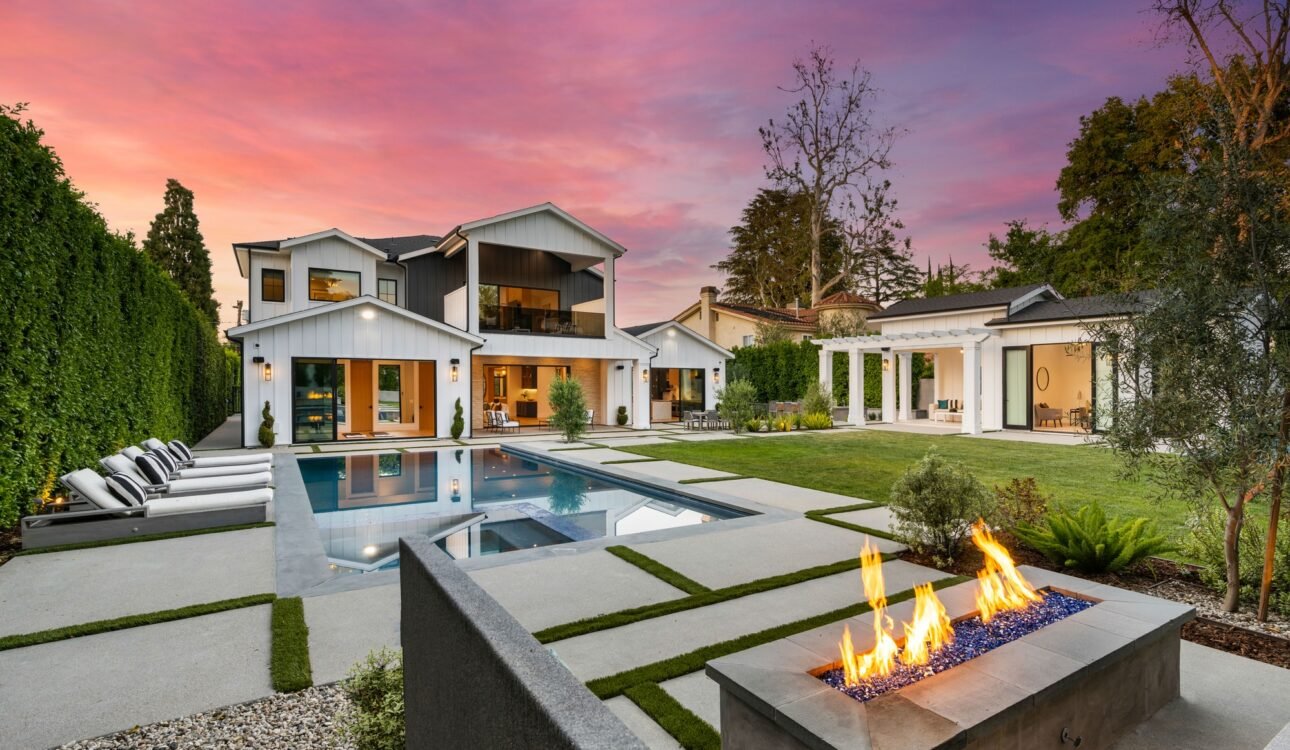 the backyard is a well maintained backyard with swimming, patio, and firepitt