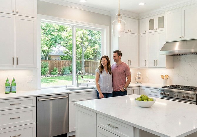 A satisfied couple in their newly renovated Dallas home, highlighting the expert kitchen remodeling available at our top Texas remodeling locations.